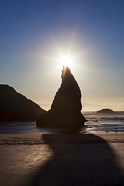 Sunset behind Wizards Hat sea stack at Bandon Beach, OR