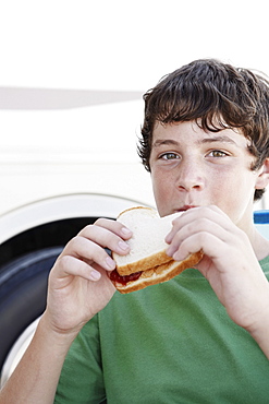 Boy eating peanut butter and jelly sandwich