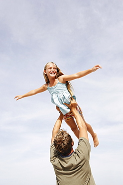 Father lifting daughter in air