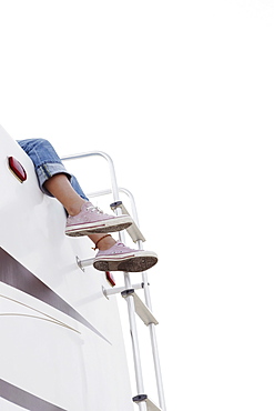 Girl sitting on top of motor home