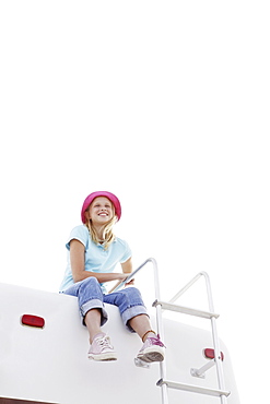 Girl sitting on top of motor home