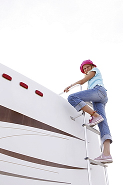 Girl climbing on motor home ladder