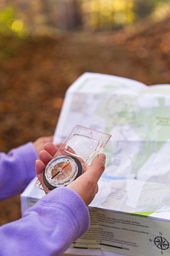 USA, New Jersey, Close-up of woman's hands holding compass and map