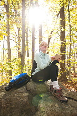 Female hiker using digital tablet in forest