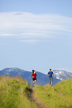 USA, Montana, Kalispell, Couple jogging in mountainside, USA, Montana, Kalispell