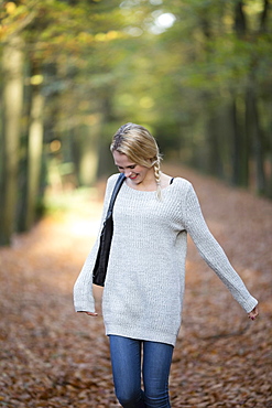 Portrait of smiling woman in autumn forest