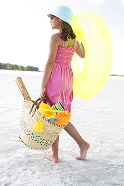 Girl carrying beach essentials