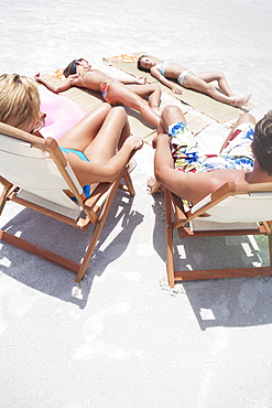Family sunbathing on beach