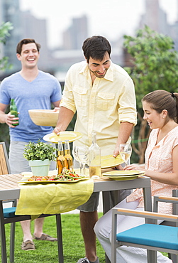 Friends enjoying barbecue in garden