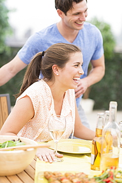 Friends enjoying meal in garden