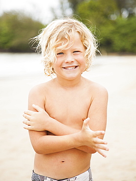 Portrait of boy (6-7) on beach, Kauai, Hawaii