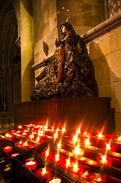 Candles in front of Virgin Mary statue in Monastery of Jeronimos, Lisbon, Portugal