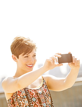 Young woman taking selfie with mobile phone