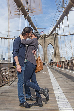 Happy couple kissing on Brooklyn Bridge, Brooklyn, New York