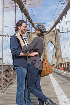 Happy couple embracing on Brooklyn Bridge, Brooklyn, New York