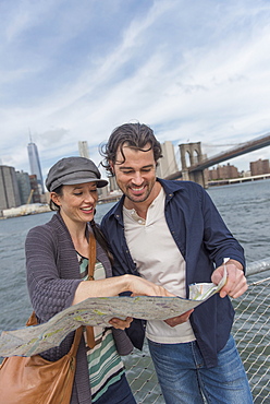 Happy couple reading map, Brooklyn, New York