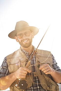 Portrait of man holding fishing rod