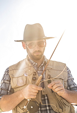 Portrait of man holding fishing rod