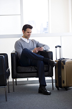 Businessman sitting in airport lounge