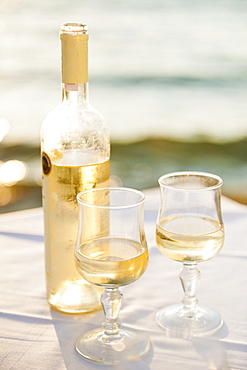 Greece, Cyclades Islands, Mykonos, Wine on table by sea