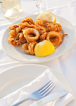 Greece, Cyclades Islands, Mykonos, Calamari appetizer on set table by sea