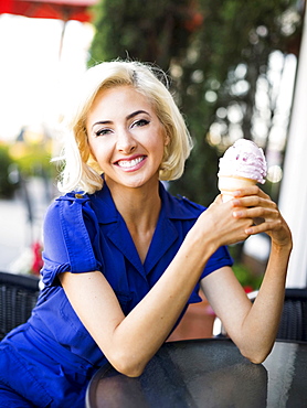 Woman posing with ice-cream, Costa Mesa, California