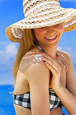 Woman applying sunscreen