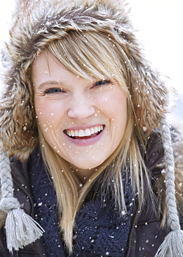 Portrait of woman wearing knit hat laughing