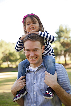 Father carrying his daughter (4-5 years) on holders, Irvine, California