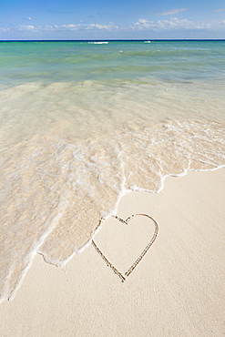 Heart drawing in sand on beach