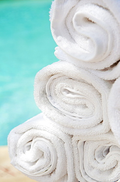 Rolled up towels in front of water