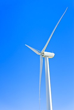 Wind turbine against blue sky