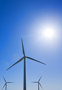 Wind turbine against blue sky