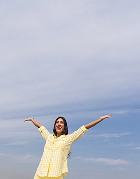 Happy woman against blue sky 