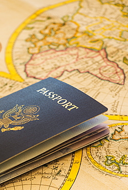 Passport sitting on antique map