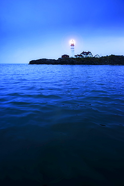 Remote coastline with lighthouse, Portland, Maine