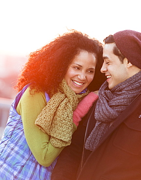 Portrait of happy couple embracing at sunset