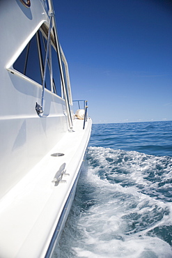 Side of a speed boat and its wake