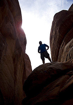 Man atop Red Rock Arches National Park Moab Utah USA