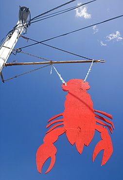 Lobster shaped sign under blue sky, Maine, United States