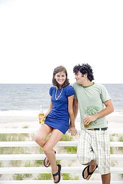 Couple drinking beer at beach