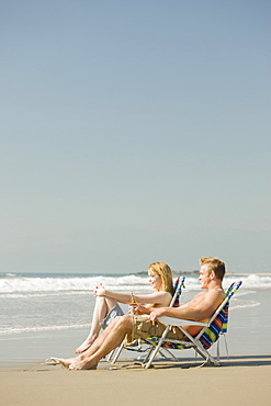 Couple sitting in beach chairs