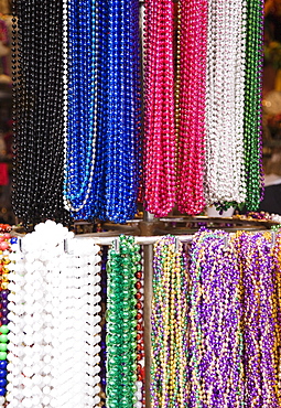 Bead necklaces hanging on rack, French Quarter, New Orleans, Louisiana, United States