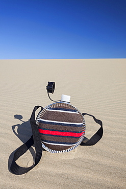 Oregon, Florence, Water bottle lying on sand dune