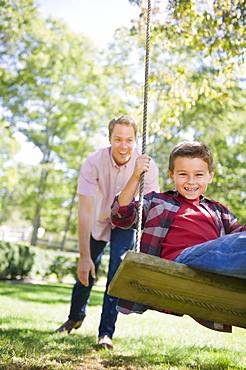 USA, New York, Flanders, Father and son (8-9) playing in garden