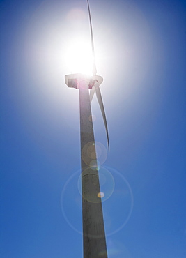 USA, California, Palm Springs, Coachella Valley, San Gorgonio Pass, Wind turbine against blue sky in sunlight