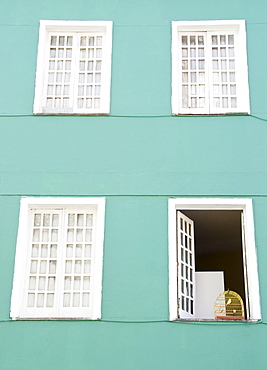 Brazil, Bahia, Salvador De Bahia, Facade of building with birdcage on open window