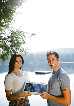 Roaring Brook Lake, Couple holding solar panel