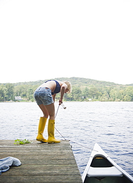 USA, New York, Putnam Valley, Roaring Brook Lake, Rear view of woman mooring boat