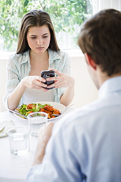 Yung woman texting over meal, USA, New Jersey, Jersey City